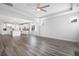Bright living room with beautiful hardwood floors that transition into a modern kitchen space at 1809 Hanwoo Ln, Powder Springs, GA 30127