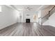 Bright living room features a fireplace, ceiling fan, and beautiful gray laminate flooring at 1809 Hanwoo Ln, Powder Springs, GA 30127