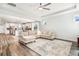 Open floor plan showcases a spacious living room with a large sectional and hardwood floors at 1809 Hanwoo Ln, Powder Springs, GA 30127