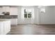 Bright, open-concept living space with large window, light gray wood flooring, and neutral paint at 1809 Hanwoo Ln, Powder Springs, GA 30127