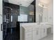 Modern bathroom boasting black marble shower, dual vanities, and sleek fixtures at 4253 Biltmore Pl, Marietta, GA 30062