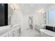 Elegant bathroom featuring dual vanities, a soaking tub, and a walk-in closet at 4253 Biltmore Pl, Marietta, GA 30062