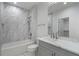 Modern bathroom with marble tile and new vanity and tub at 4253 Biltmore Pl, Marietta, GA 30062