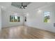 Spacious bedroom with hardwood floors, recessed lights, tray ceiling, and multiple windows at 4253 Biltmore Pl, Marietta, GA 30062