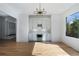 Open-concept dining room with a modern light fixture, built-in wine rack, and hardwood flooring at 4253 Biltmore Pl, Marietta, GA 30062