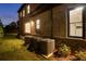Brick home exterior with multiple AC units, a window, and a partial view of a garage door at 4253 Biltmore Pl, Marietta, GA 30062