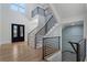 Bright foyer featuring a grand staircase with iron railings and hardwood floors for an elegant entry at 4253 Biltmore Pl, Marietta, GA 30062