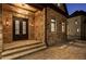 Elegant home entrance with stone facade, double doors, and paver walkway, creating a welcoming ambiance at 4253 Biltmore Pl, Marietta, GA 30062