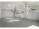Spacious four-car garage with white doors, ample lighting, and sealed concrete floor at 4253 Biltmore Pl, Marietta, GA 30062