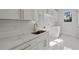 Bright laundry room featuring white cabinets, quartz countertops and shiplap backsplash at 4253 Biltmore Pl, Marietta, GA 30062