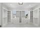 A spacious walk-in closet with custom white cabinets, drawers, shelves and marble floor at 4253 Biltmore Pl, Marietta, GA 30062