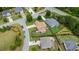 An aerial view showcases a home with a backyard patio and manicured lawns in a quiet neighborhood at 5805 Fielding Ct, Cumming, GA 30041