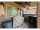 Back porch with grill, brick accents, and ceiling fan at 5805 Fielding Ct, Cumming, GA 30041