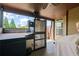 Outdoor kitchen with grill setup, ceiling fan, and view of the backyard at 5805 Fielding Ct, Cumming, GA 30041