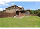 Fenced backyard with green grass, patio, and planting beds at 5805 Fielding Ct, Cumming, GA 30041