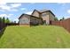 Wide shot of the backyard showing grass and fence at 5805 Fielding Ct, Cumming, GA 30041