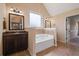 Bright bathroom with a soaking tub, double vanity, and a neutral color scheme at 5805 Fielding Ct, Cumming, GA 30041