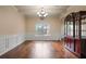 Elegant dining room featuring coffered ceilings, chandelier, and a large window with backyard views at 5805 Fielding Ct, Cumming, GA 30041