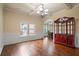Bright dining room showcasing hardwood floors, elegant lighting, and archways to other rooms at 5805 Fielding Ct, Cumming, GA 30041