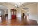 Open dining area with hardwood flooring, wainscoting and archways to adjacent rooms at 5805 Fielding Ct, Cumming, GA 30041