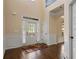 Elegant foyer with hardwood floors, high ceilings, wainscoting, and ample natural light at 5805 Fielding Ct, Cumming, GA 30041