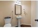 Cozy half bathroom features a pedestal sink, and a decorative mirror at 5805 Fielding Ct, Cumming, GA 30041