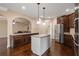 Modern kitchen with stainless steel appliances, granite countertops, and an island with seating at 5805 Fielding Ct, Cumming, GA 30041