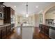 Gourmet kitchen featuring granite counters, stainless steel appliances, dark cabinetry, and a large island at 5805 Fielding Ct, Cumming, GA 30041