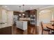 Modern kitchen with stainless steel appliances, granite countertops, an island, and dark wood cabinetry at 5805 Fielding Ct, Cumming, GA 30041