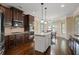 Spacious kitchen with an island, granite counters, stainless steel appliances, and dark wood cabinets at 5805 Fielding Ct, Cumming, GA 30041