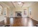 Spacious living room with stone fireplace, hardwood floors, and access to the backyard at 5805 Fielding Ct, Cumming, GA 30041