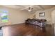 Spacious living room with hardwood floors, ceiling fan, and a comfortable leather sofa at 5805 Fielding Ct, Cumming, GA 30041