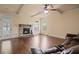 Cozy living room featuring a stone fireplace, hardwood floors, and large windows at 5805 Fielding Ct, Cumming, GA 30041