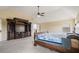 Well-lit main bedroom with a vaulted ceiling, large media cabinet and plush carpeting at 5805 Fielding Ct, Cumming, GA 30041
