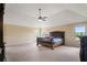 Spacious main bedroom with a tray ceiling, plush carpet, and large windows at 5805 Fielding Ct, Cumming, GA 30041