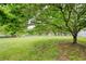 Lush backyard with mature trees and a play structure, providing ample space for outdoor enjoyment at 7925 Silversmith Dr, Cumming, GA 30028