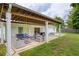 Outdoor living on a covered patio with backyard view, seating, and swing for outdoor enjoyment at 7925 Silversmith Dr, Cumming, GA 30028