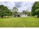 Expansive backyard view showcases a well-maintained lawn and a covered patio perfect for relaxation and entertainment at 7925 Silversmith Dr, Cumming, GA 30028