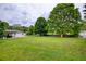 Large backyard with a play structure, mature trees, and plenty of space to enjoy the outdoors at 7925 Silversmith Dr, Cumming, GA 30028
