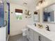 Bright bathroom featuring double sink vanity, a toilet, and a glass-encased blue tiled shower at 7925 Silversmith Dr, Cumming, GA 30028