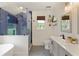 Well-lit bathroom featuring a glass-enclosed blue-tiled shower, patterned tile floor, and dual sink vanity at 7925 Silversmith Dr, Cumming, GA 30028