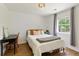 Bedroom with white walls, wood floors, a large window, and a desk area at 7925 Silversmith Dr, Cumming, GA 30028