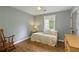 Cozy bedroom featuring wood floors, a twin daybed, and a rocking chair at 7925 Silversmith Dr, Cumming, GA 30028