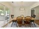 Bright dining room with wainscotting and sliding glass door leading to the backyard at 7925 Silversmith Dr, Cumming, GA 30028