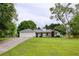 Charming home featuring a well-manicured lawn, inviting front porch, and a two-car garage for ample parking at 7925 Silversmith Dr, Cumming, GA 30028
