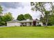 Charming home with a well-manicured lawn, mature trees, and an attached two-car garage at 7925 Silversmith Dr, Cumming, GA 30028