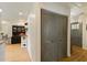 Hallway featuring wood-look flooring, a sliding barn door, and a glimpse of the kitchen at 7925 Silversmith Dr, Cumming, GA 30028