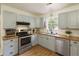 Well-lit kitchen with stainless steel appliances, butcher block countertops and light blue cabinets at 7925 Silversmith Dr, Cumming, GA 30028
