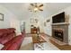 Bright and inviting living room with a cozy fireplace and comfortable furniture at 7925 Silversmith Dr, Cumming, GA 30028
