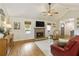 Cozy living room with hardwood floors, fireplace, and neutral tones provides a welcoming atmosphere at 7925 Silversmith Dr, Cumming, GA 30028